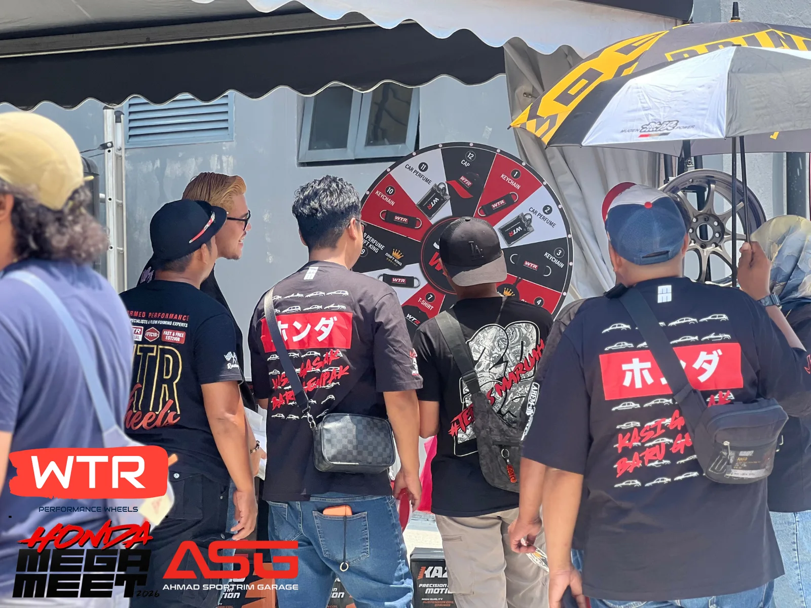 Visitors gather around the WTR prize wheel at an ASG community event