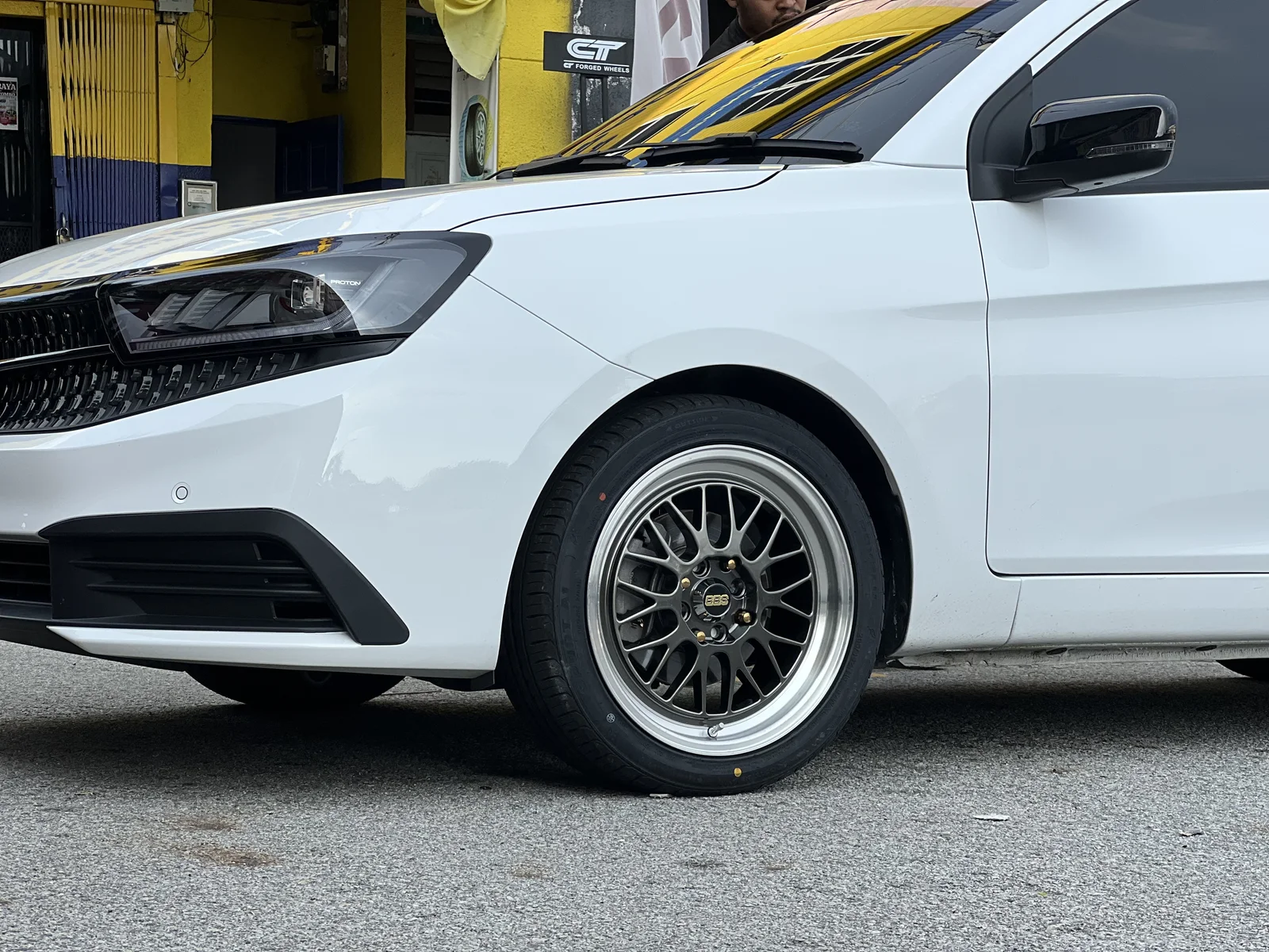 White Proton fitted with a dark multi-spoke performance rim