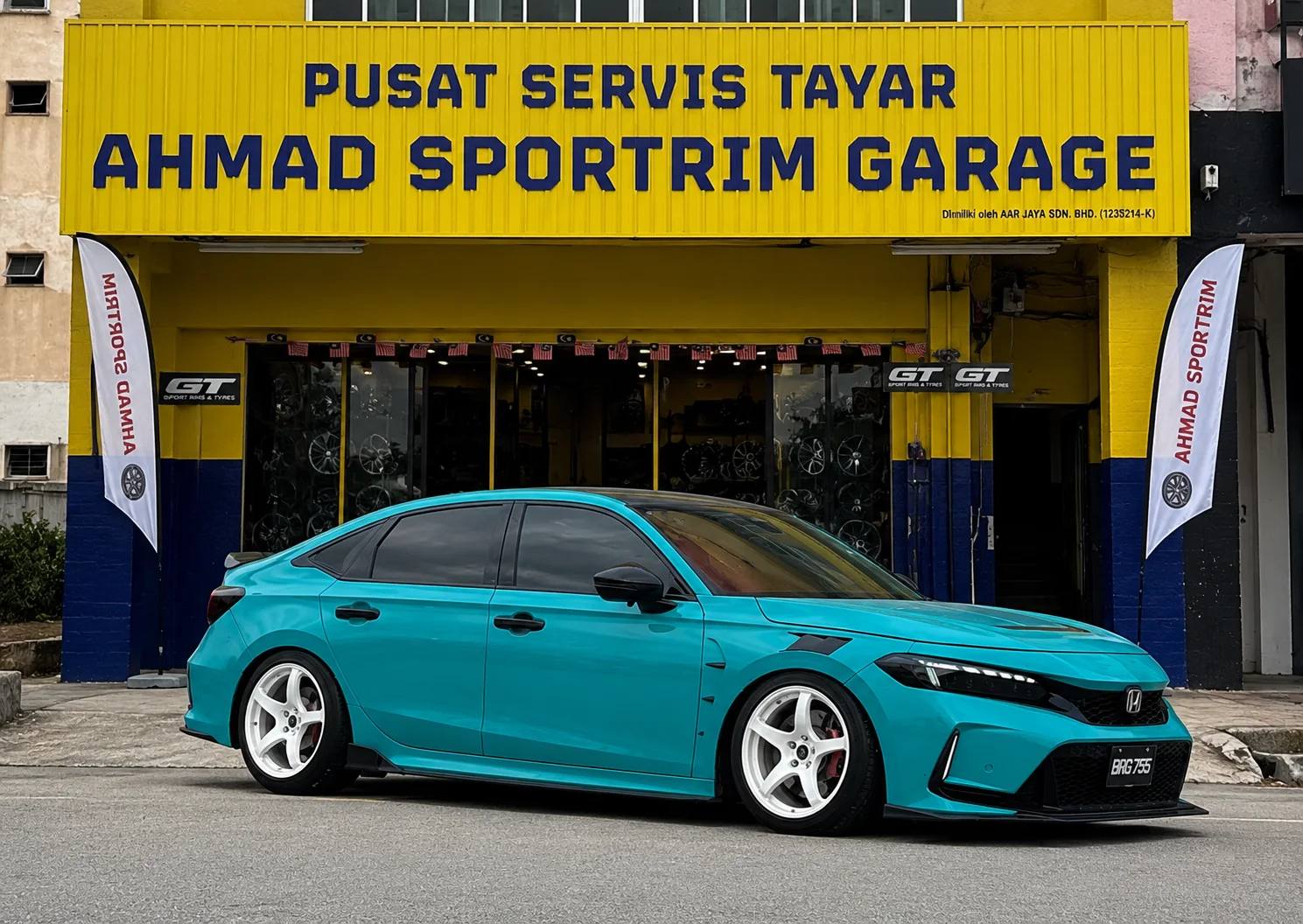 Teal Honda Civic sedan with silver five-spoke wheels outside ASG