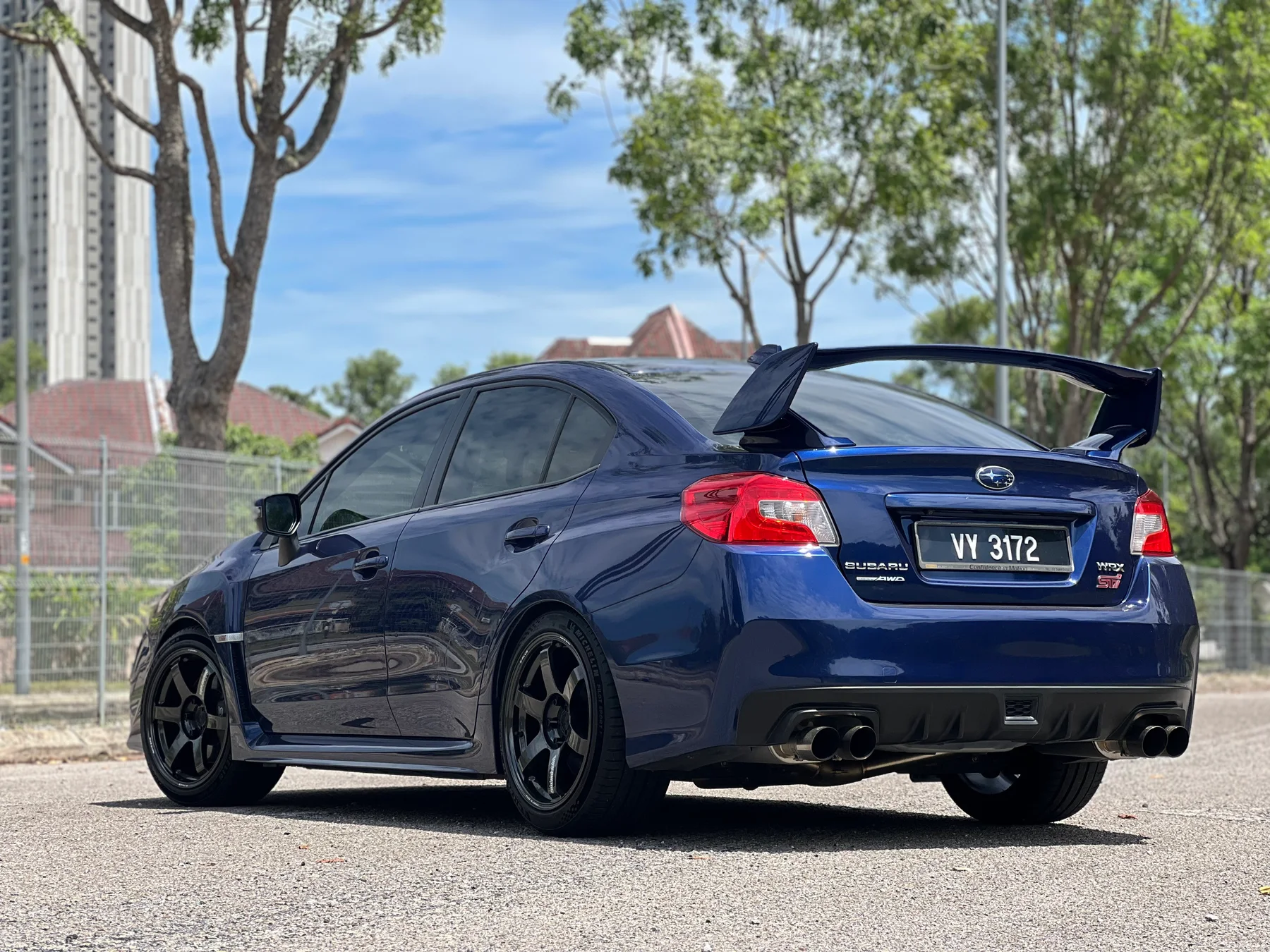 Blue BMW sedan with dark multi-spoke wheels
