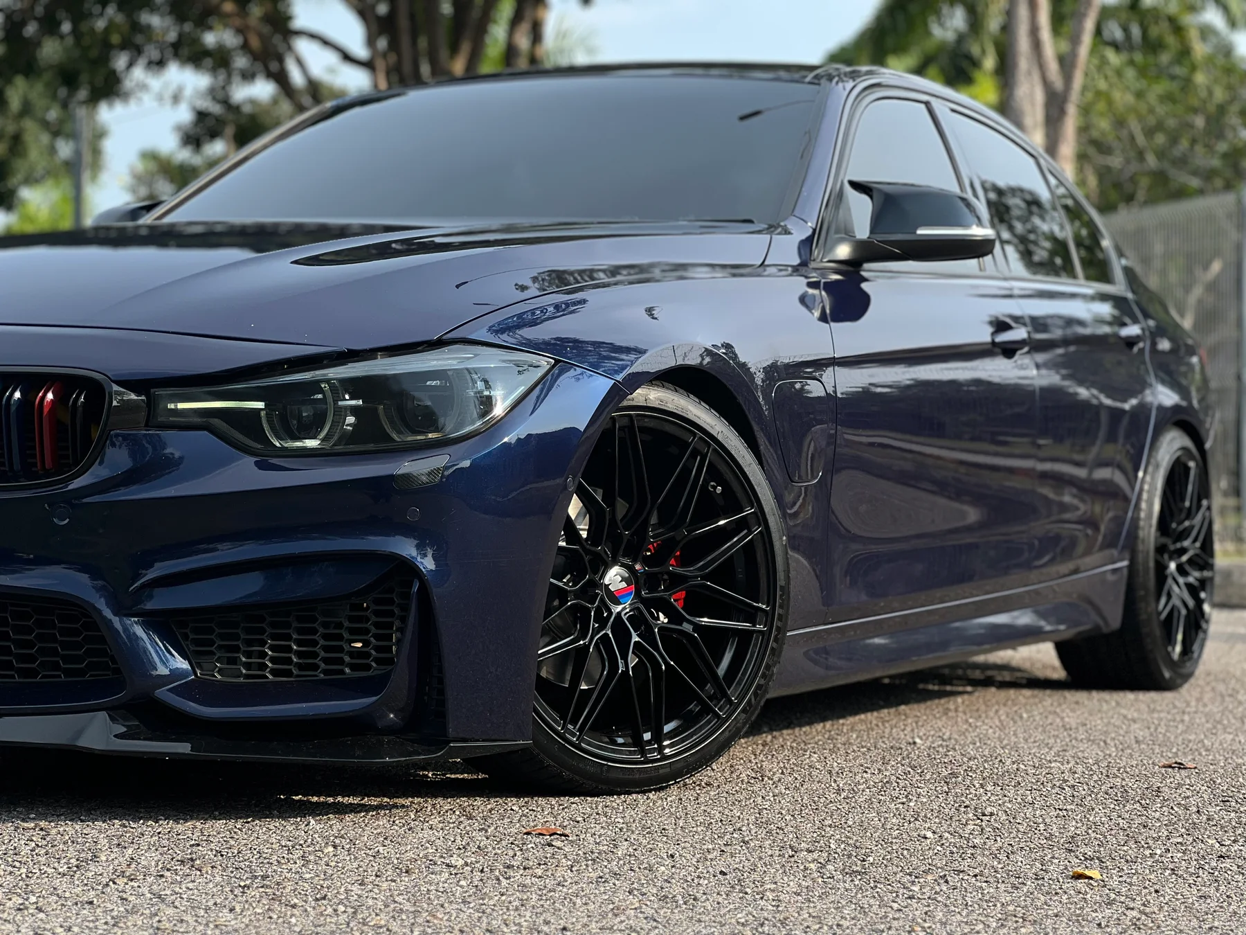 Blue BMW performance sedan with black multi-spoke wheels