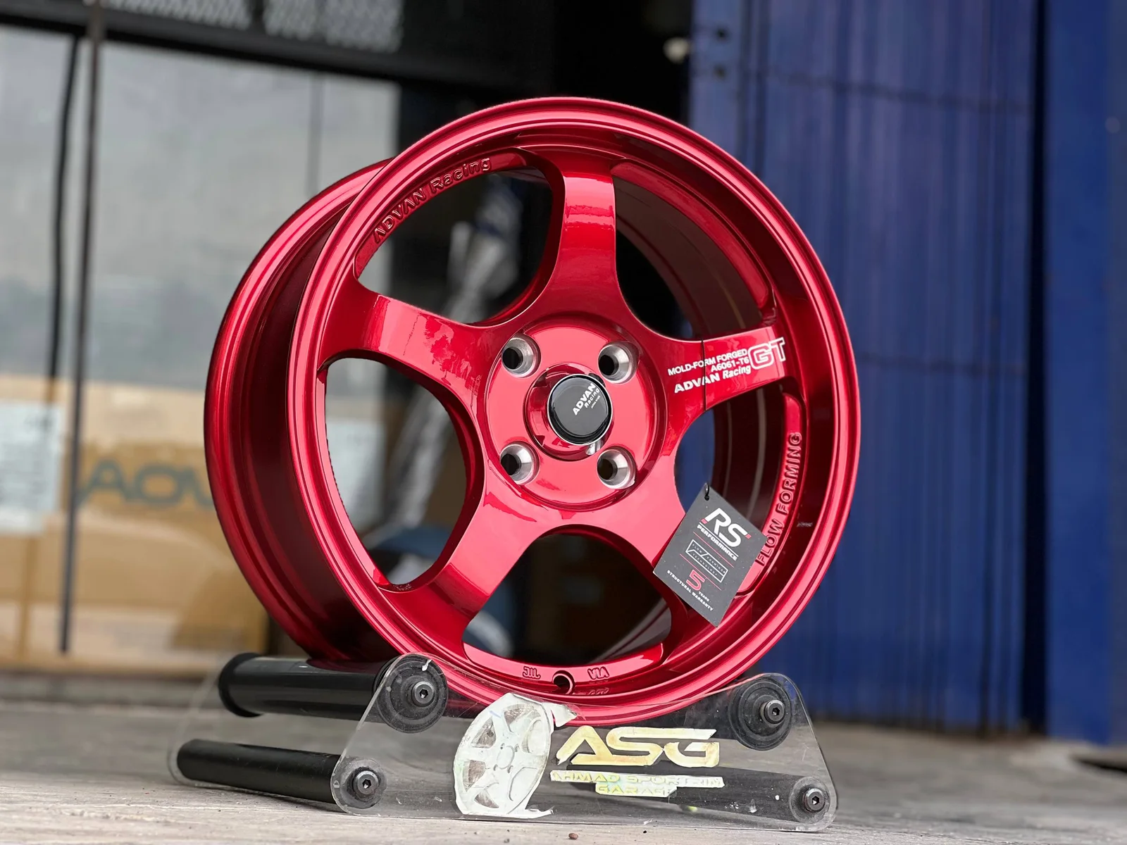 Red six-spoke 15-inch sport rim displayed at Ahmad Sportrim Garage