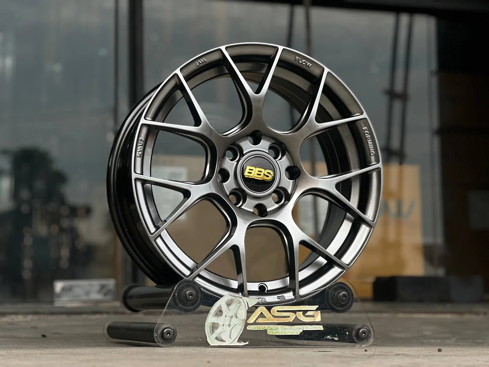 Dark multi-spoke 15-inch sport rim displayed at Ahmad Sportrim Garage