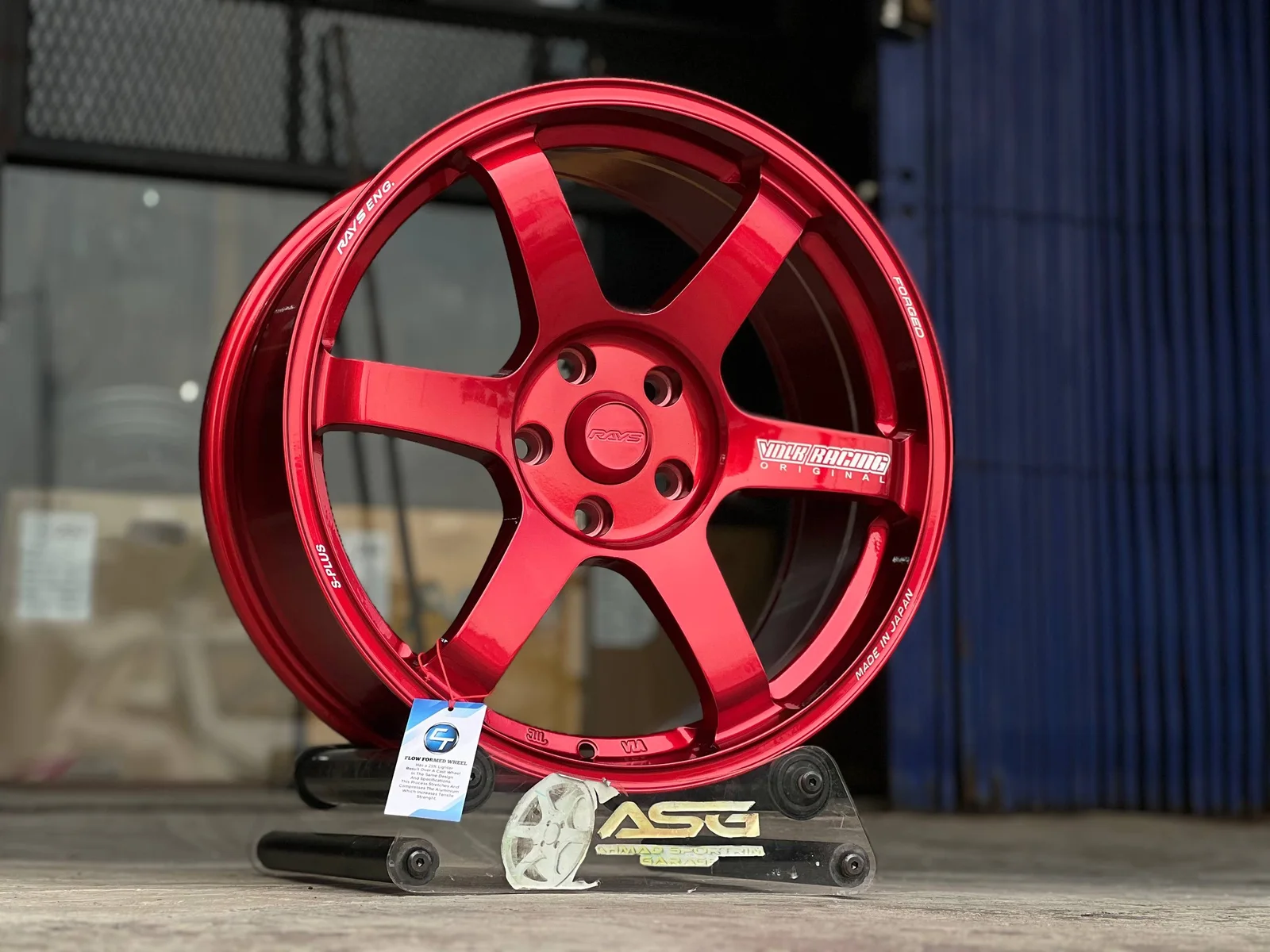 Red six-spoke 18-inch sport rim displayed at Ahmad Sportrim Garage