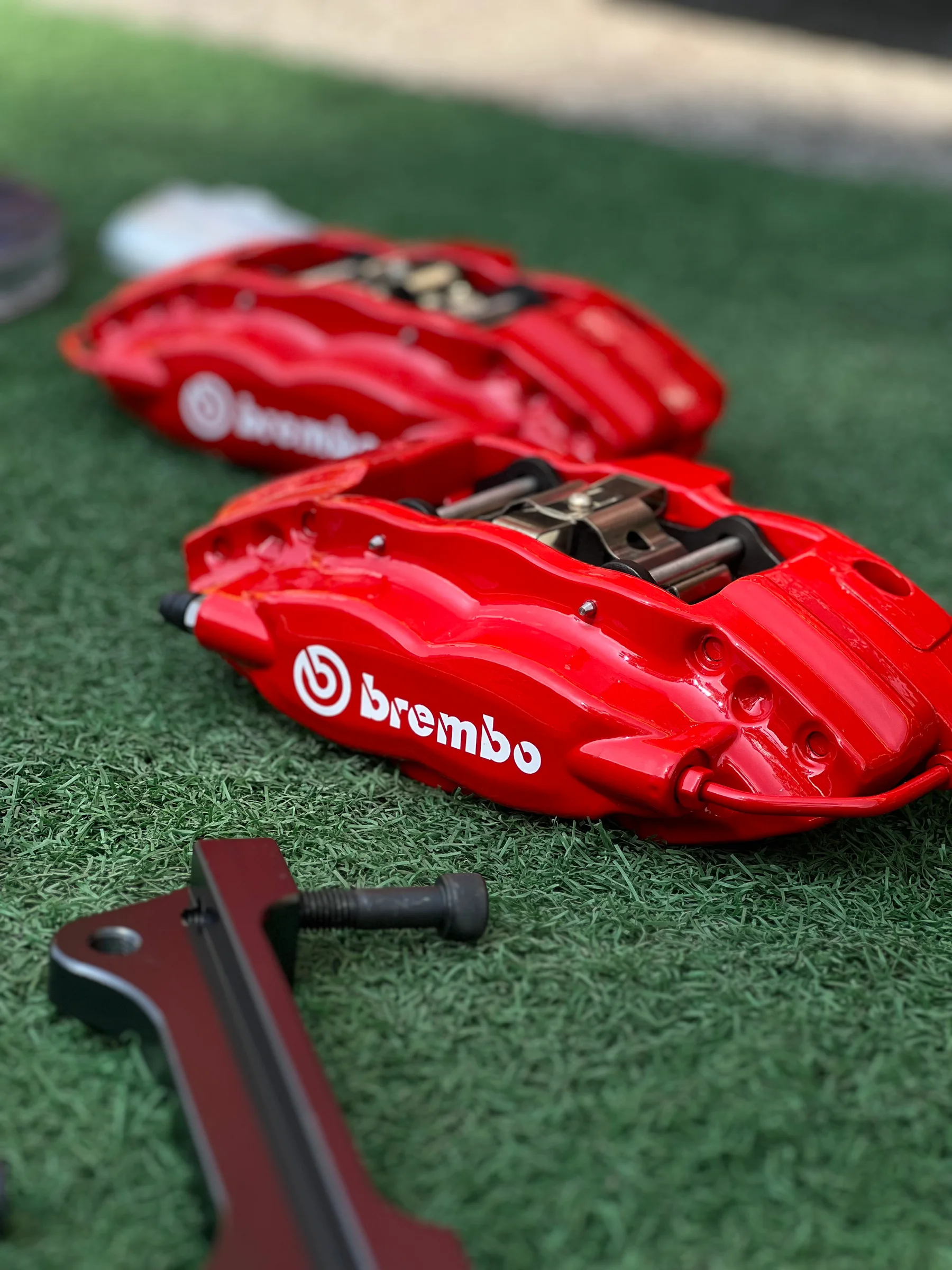 Red Brembo performance brake caliper displayed at ASG