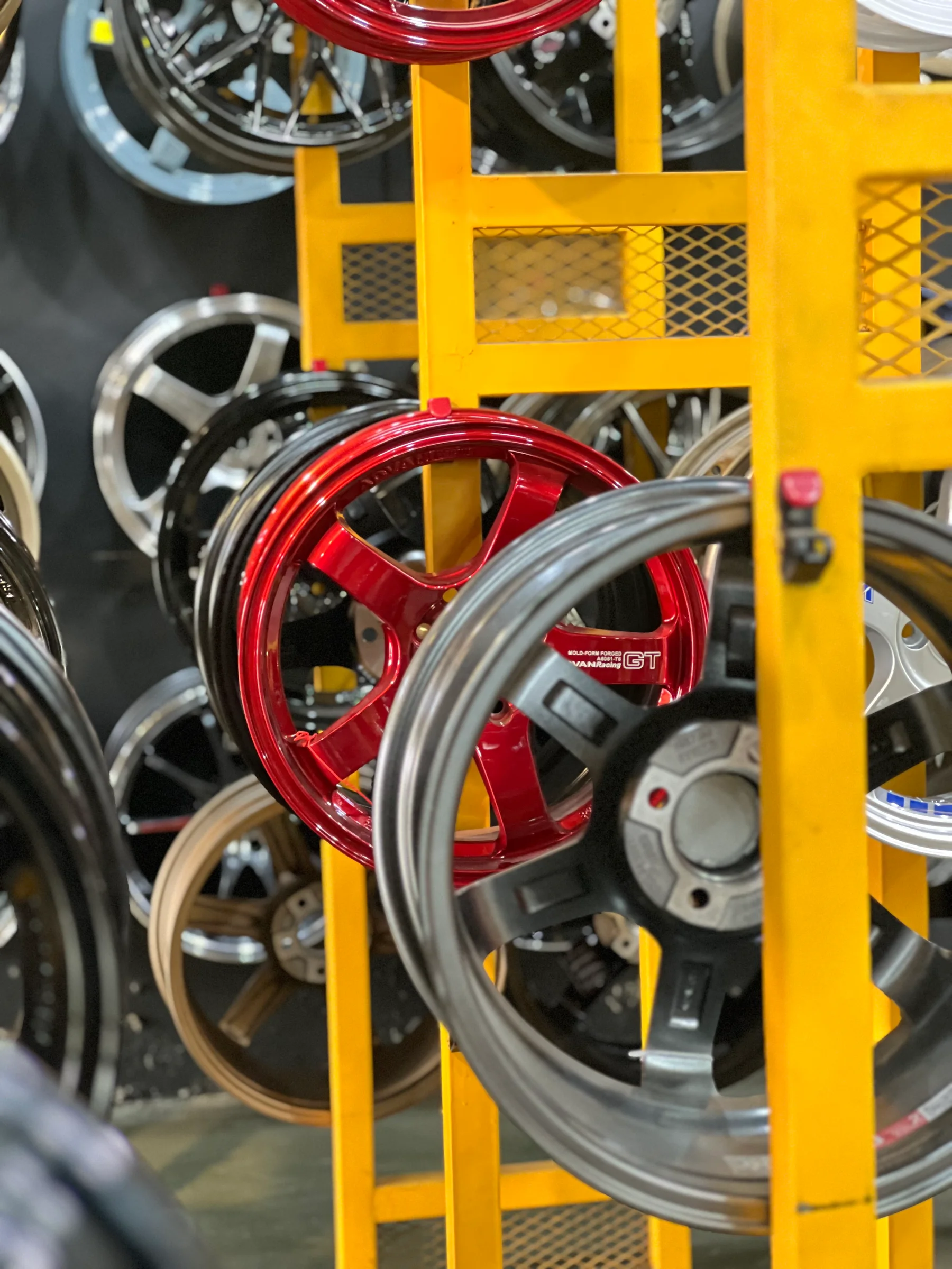 Red and silver sport rims displayed in the ASG showroom