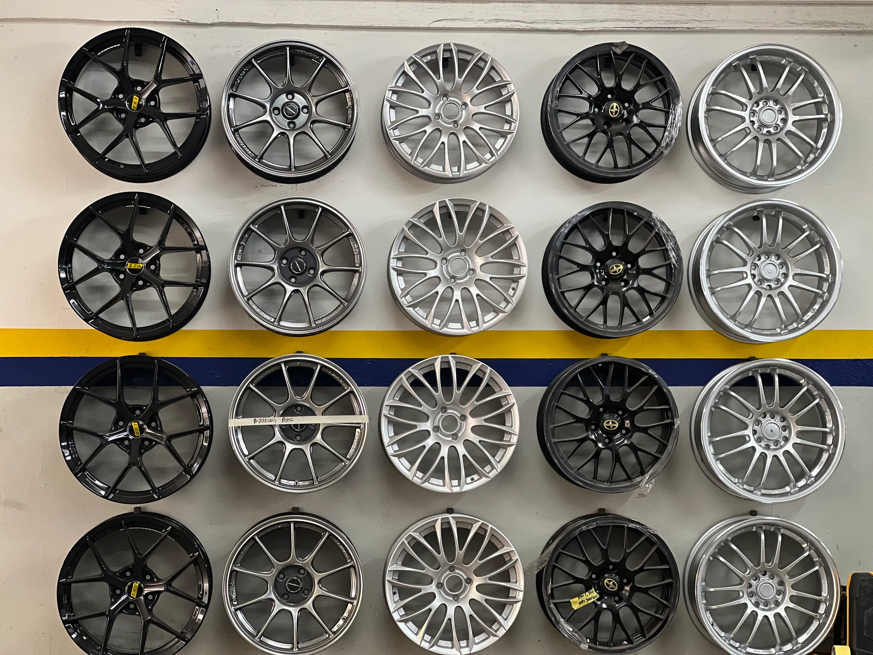 Rows of sport rim designs displayed on the ASG showroom wall