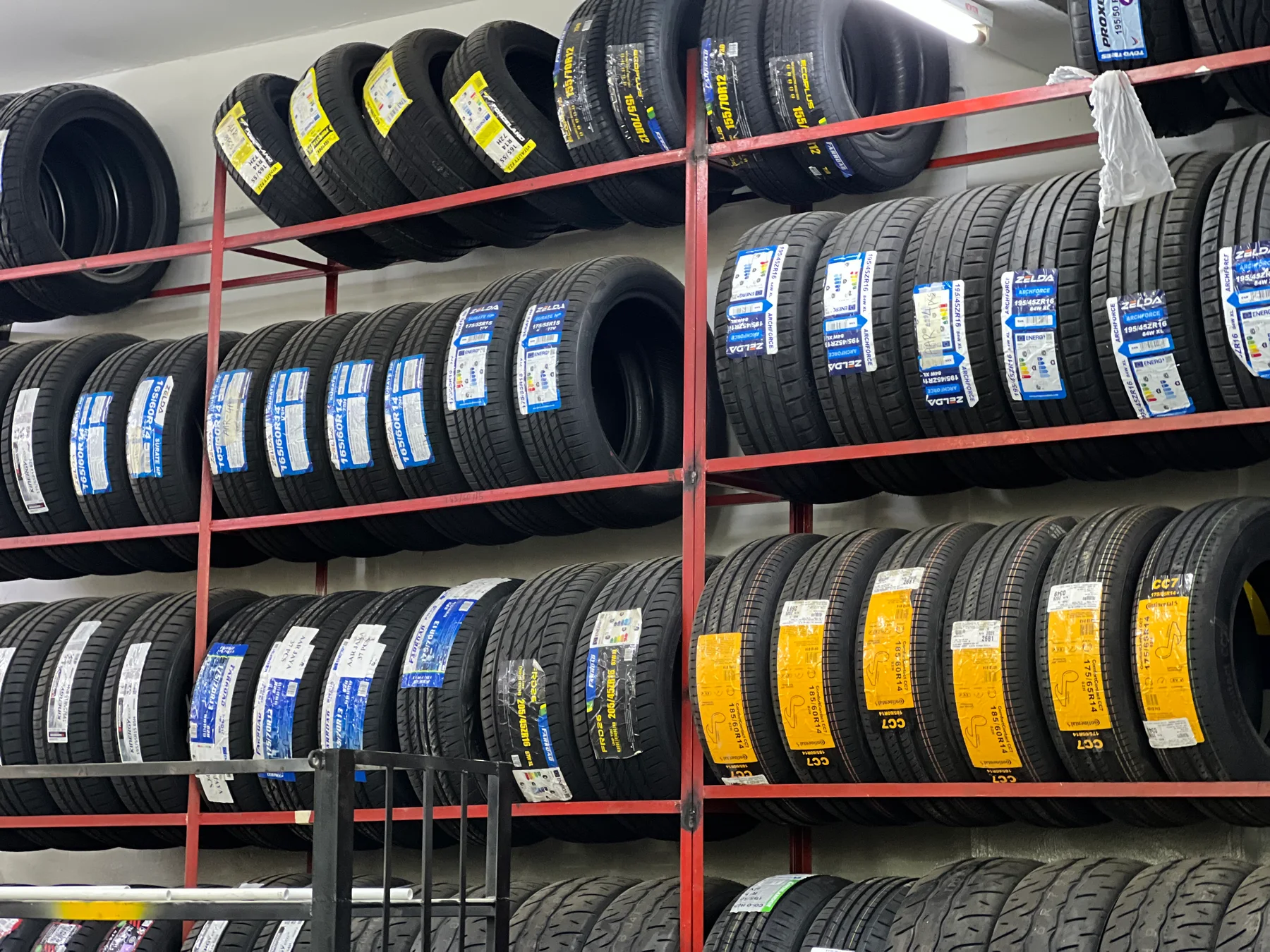 Rows of tyre stock displayed on red racks at ASG