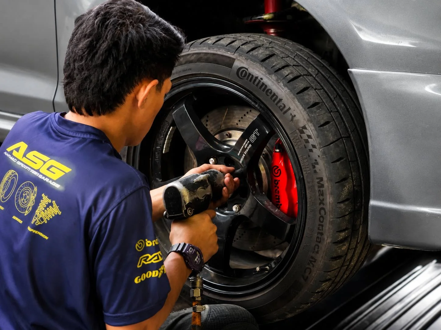 ASG technician installing a performance sport rim on a customer car